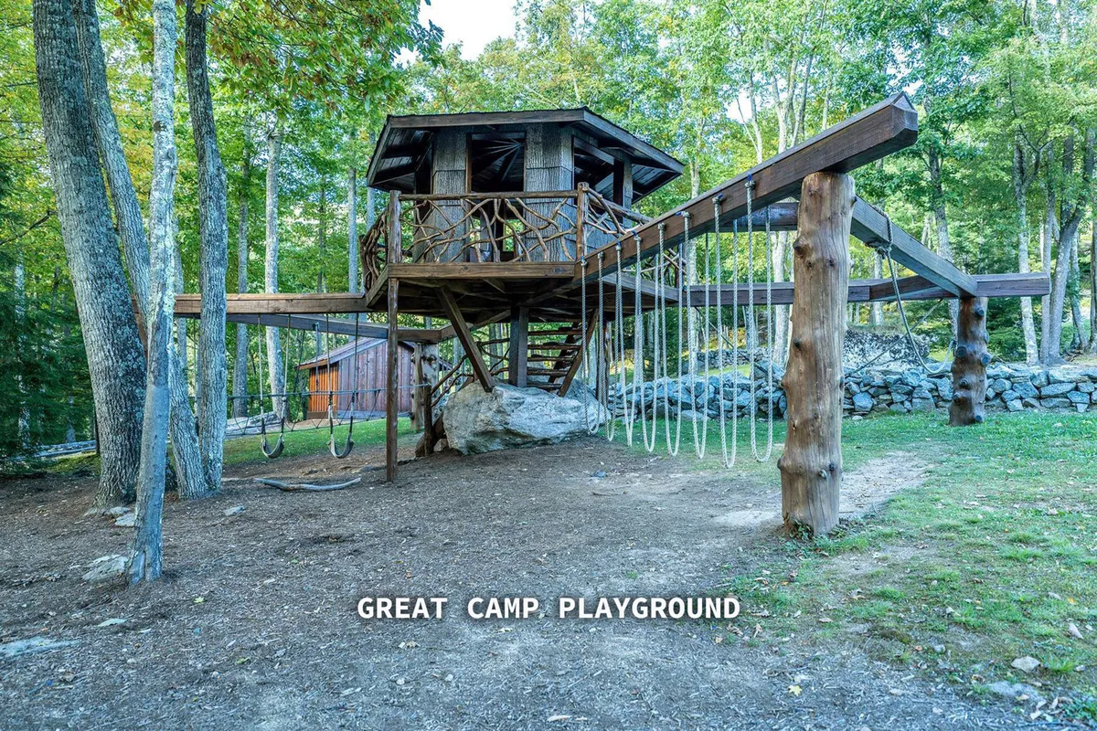 A playful playground structure surrounded by trees, with children actively exploring and socializing. The setting is energetic and welcoming, reflecting the family-friendly, communal atmosphere of the neighborhood’s amenities.